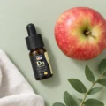 HEKA Kids Vitamin D3 Drops with an apple and green leaves
